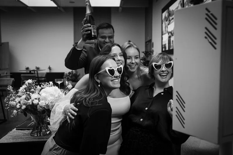 Guests enjoying a customized photo booth during an intimate wedding celebration at Scala Ghent, featuring a popcorn and gelato station.